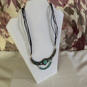 Four long strings of thin black leather chain, large half moon metal pendant